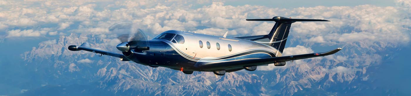 Pilatus PC-12 flying over Mountain Range